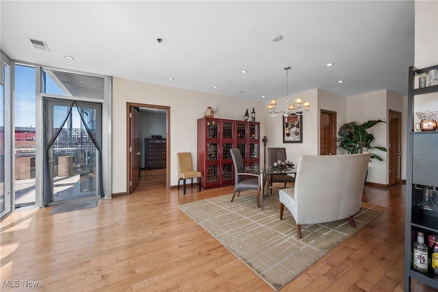 living room featuring visible vents, recessed lighting, light wood finished floors, and an inviting chandelier