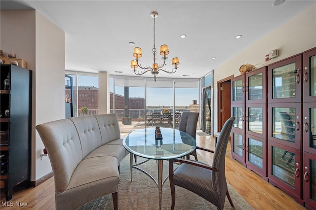 dining space with recessed lighting, a chandelier, floor to ceiling windows, and light wood-style floors