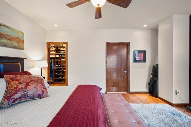 bedroom with baseboards, recessed lighting, ceiling fan, and wood finished floors