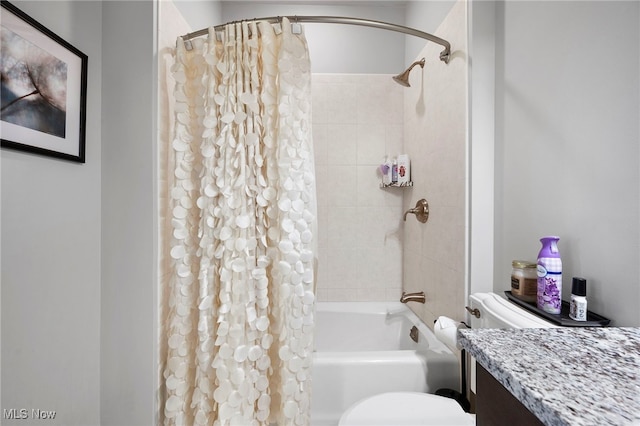 full bath featuring vanity, shower / bath combo with shower curtain, and toilet