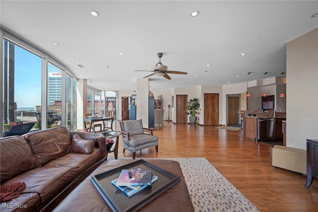 living room with a ceiling fan, recessed lighting, light wood finished floors, and visible vents