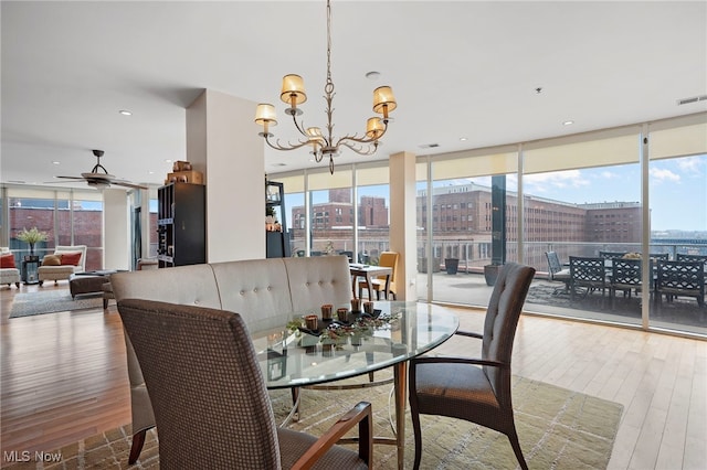 dining area featuring floor to ceiling windows, wood finished floors, and a wealth of natural light
