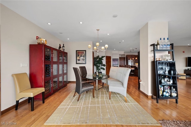living area featuring recessed lighting, a chandelier, and light wood-style flooring