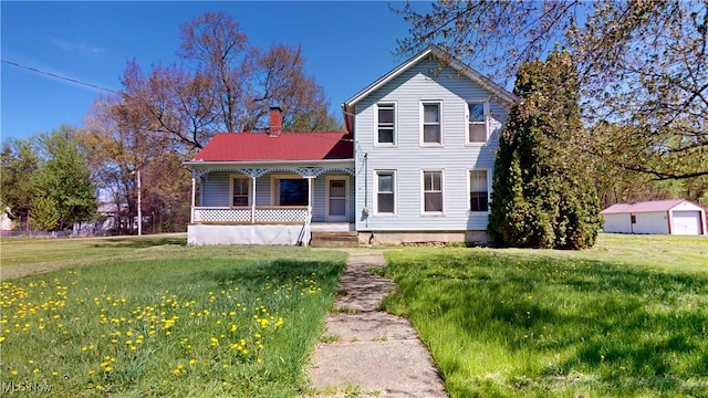 view of front of home featuring a porch, a front yard, and a chimney