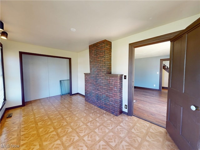 unfurnished living room featuring baseboards, light wood finished floors, and visible vents