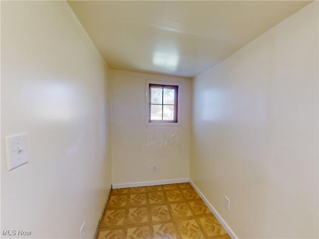 spare room featuring baseboards