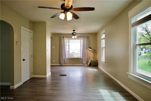 918 Pitkin Ave, Akron, OH 44310 - spare room featuring arched walkways, dark wood-style floors, plenty of natural light, and visible vents