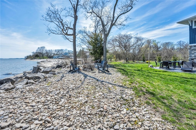 view of yard featuring a water view and a patio area