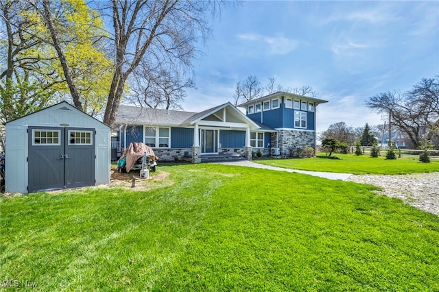 back of property featuring a storage unit, an outdoor structure, a lawn, and stone siding