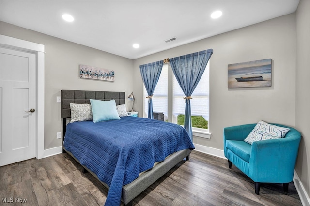 bedroom featuring baseboards, recessed lighting, wood finished floors, and visible vents