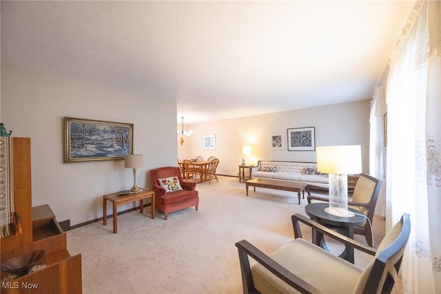 living room with carpet floors and a chandelier