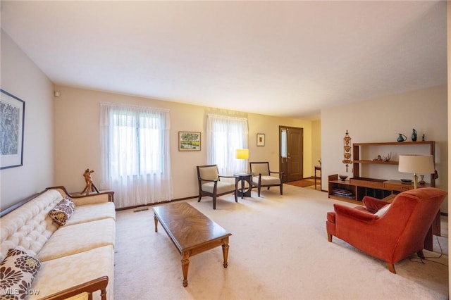living room featuring visible vents and light colored carpet