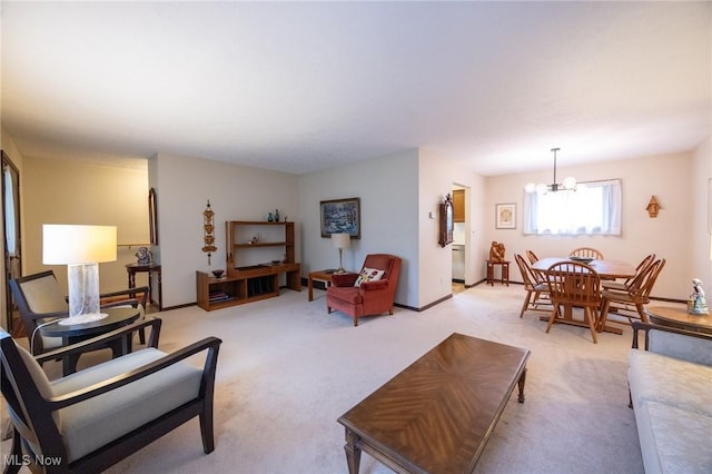 living room with baseboards, light carpet, and a chandelier