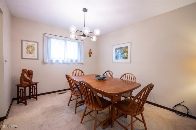 dining room featuring an inviting chandelier, baseboards, light carpet, and visible vents
