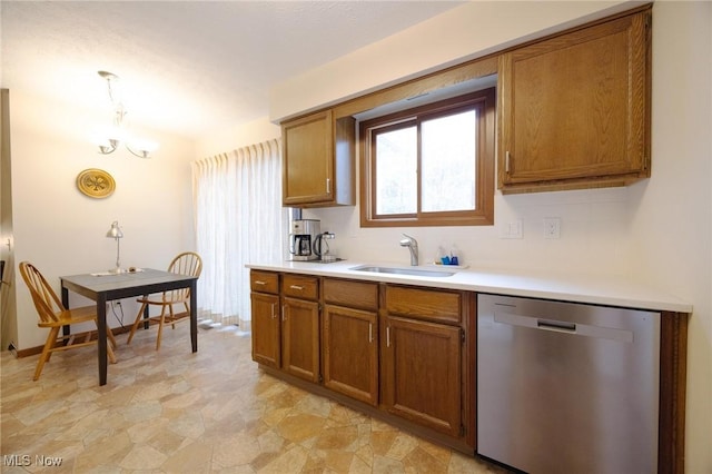 kitchen featuring a sink, light countertops, brown cabinets, and dishwasher