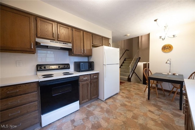 kitchen with freestanding refrigerator, electric range, black microwave, light countertops, and under cabinet range hood