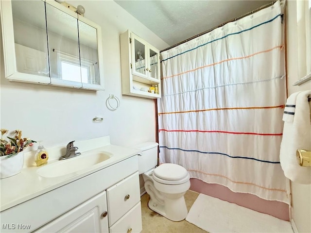 bathroom featuring vanity, toilet, a textured ceiling, and a shower with shower curtain