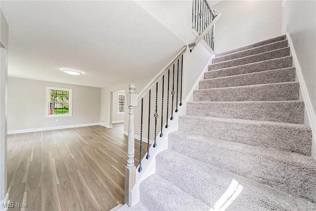 stairs featuring baseboards and wood finished floors