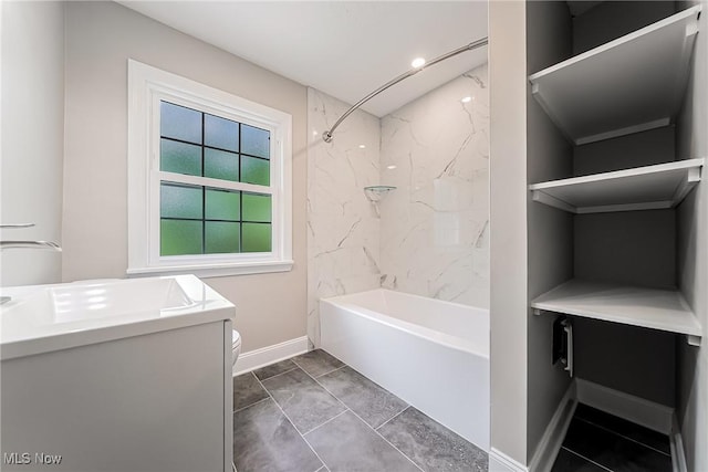 full bath featuring toilet, baseboards, washtub / shower combination, and vanity