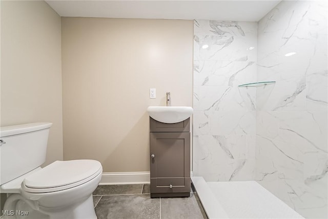 full bathroom with toilet, baseboards, walk in shower, and vanity