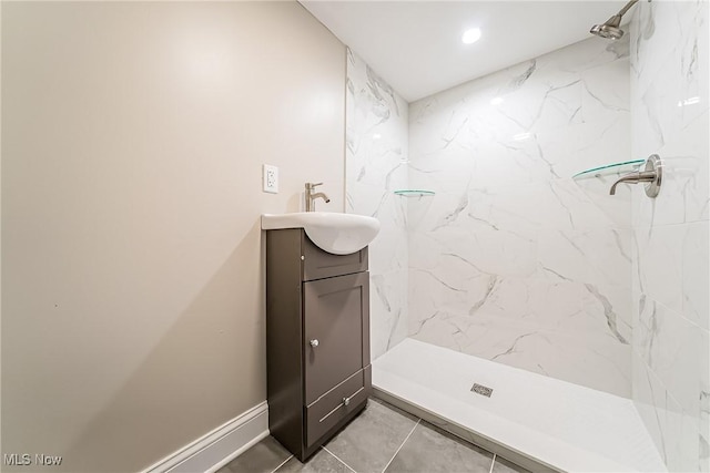 full bathroom with a stall shower, baseboards, recessed lighting, and vanity