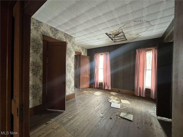 8240 Wooster Pike Rd, Seville, OH 44273 - spare room featuring wallpapered walls, wood-type flooring, and baseboards