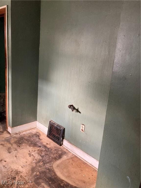 interior space with visible vents, baseboards, and concrete flooring