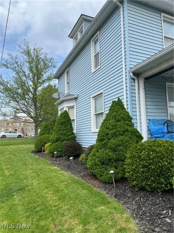 view of side of home featuring a lawn