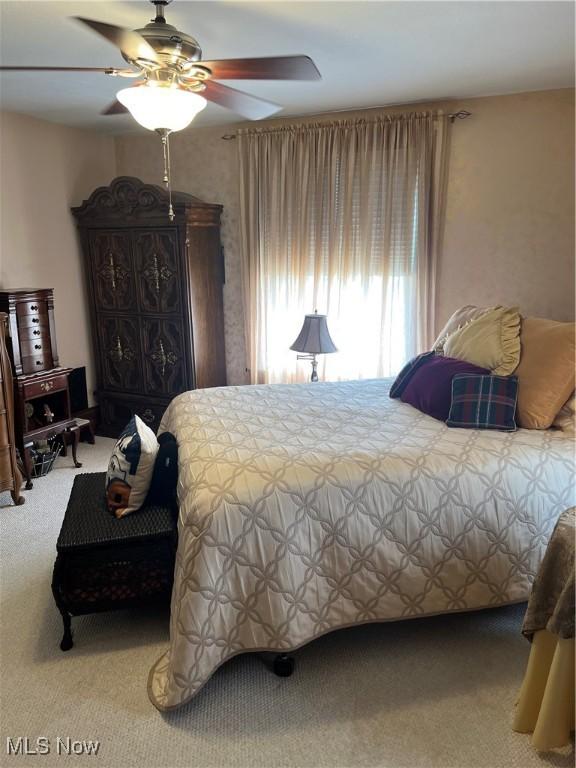 carpeted bedroom with a ceiling fan