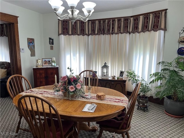 carpeted dining room featuring a chandelier and a healthy amount of sunlight