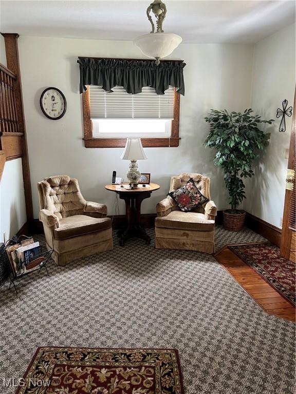 sitting room featuring baseboards and wood finished floors