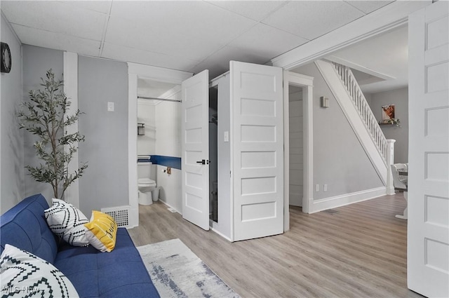 288 College St, Wadsworth, OH 44281 - living area featuring baseboards, visible vents, wood finished floors, and stairway