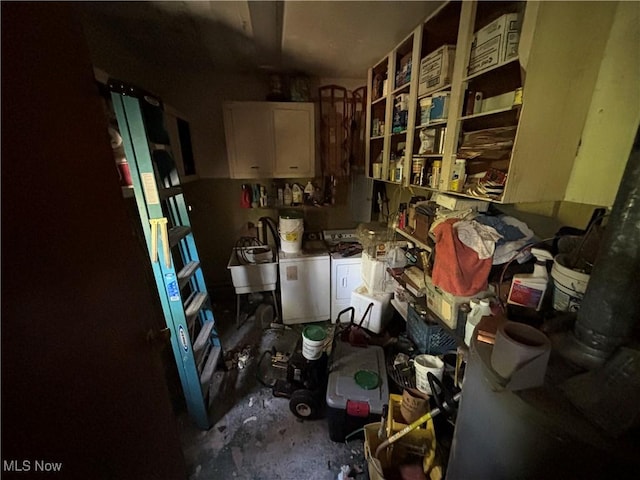 misc room featuring washing machine and dryer and a sink