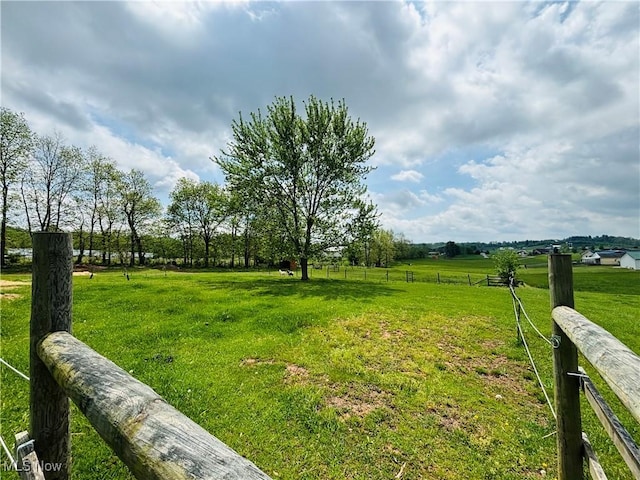 view of yard featuring fence and a rural view