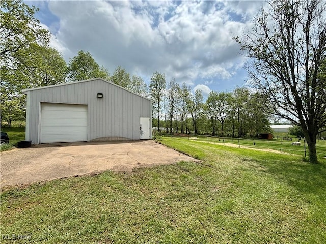 exterior space with a garage, an outbuilding, and concrete driveway