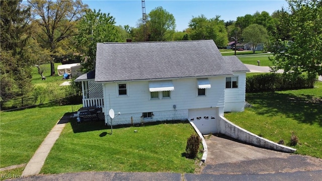 view of side of home with a lawn, driveway, and a garage