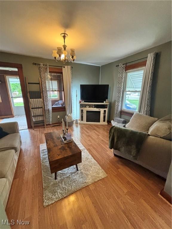living room featuring a chandelier and wood finished floors