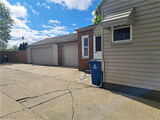 367 6th St, Campbell, OH 44405 - garage with driveway and fence