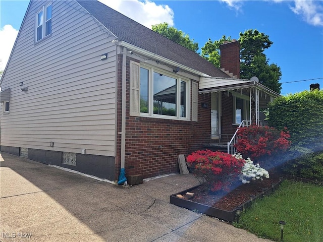 367 6th St, Campbell, OH 44405 - view of property exterior featuring brick siding, a shingled roof, and a chimney