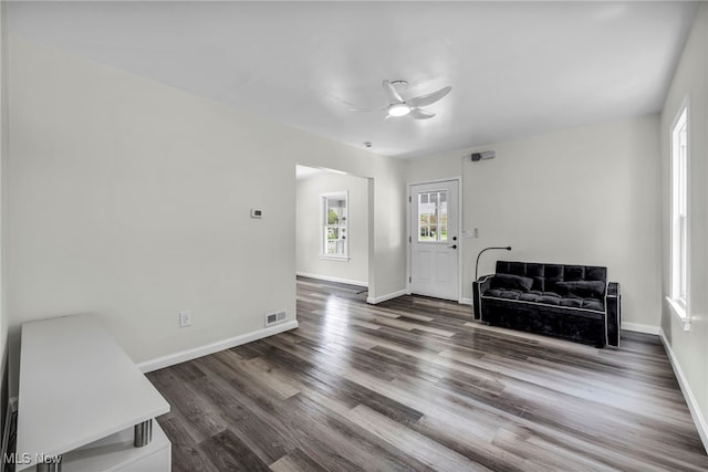 838 N Lincoln Ave, Alliance, OH 44601 - unfurnished living room with a ceiling fan, baseboards, visible vents, and wood finished floors