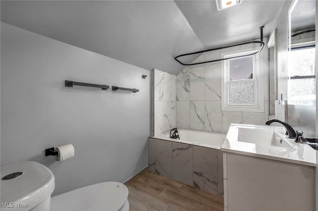 838 N Lincoln Ave, Alliance, OH 44601 - bathroom with vanity, toilet, lofted ceiling, wood tiled floor, and a combined bath / shower with marble appearance