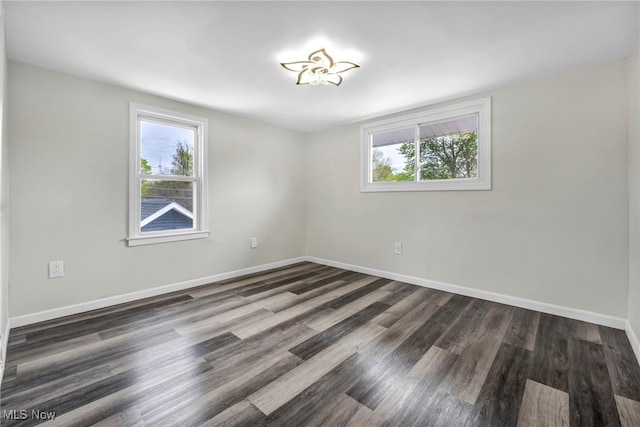 838 N Lincoln Ave, Alliance, OH 44601 - spare room featuring baseboards, wood finished floors, and a healthy amount of sunlight