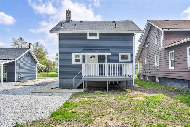 838 N Lincoln Ave, Alliance, OH 44601 - back of house featuring roof with shingles, a wooden deck, and a chimney