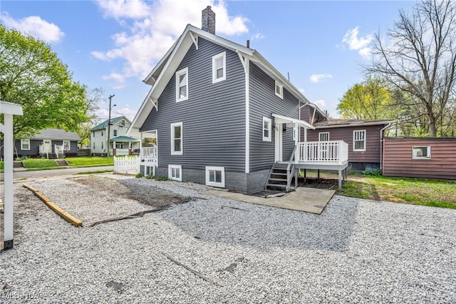 838 N Lincoln Ave, Alliance, OH 44601 - back of property featuring a patio area, a wooden deck, and a chimney