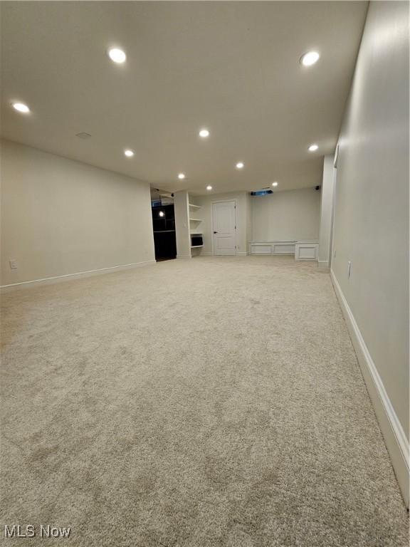 below grade area featuring carpet floors, baseboards, and recessed lighting
