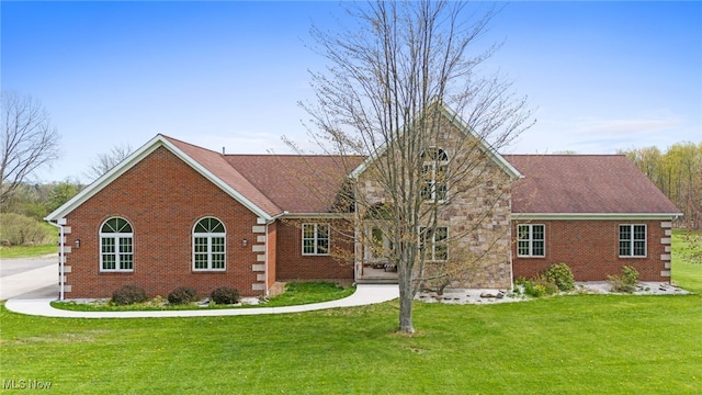 view of front of property with brick siding and a front lawn
