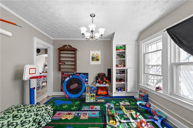 1335 W Blvd, Cleveland, OH 44102 - playroom with ornamental molding, wood finished floors, baseboards, a textured ceiling, and a chandelier