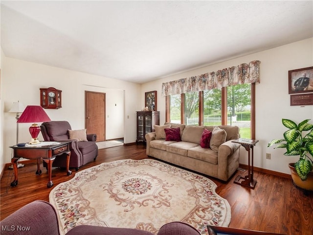 living area with baseboards and wood finished floors