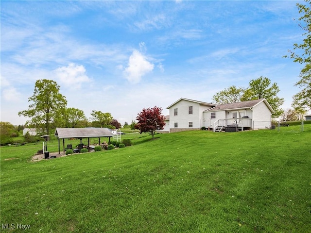 view of yard featuring a wooden deck and a carport