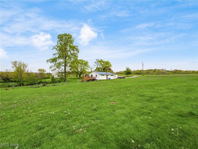 view of yard with a wooden deck and a rural view